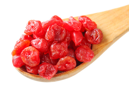 Dried cherries on wooden spoon